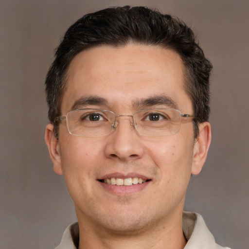 Joyful white adult male with short  brown hair and brown eyes