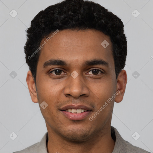 Joyful black young-adult male with short  black hair and brown eyes