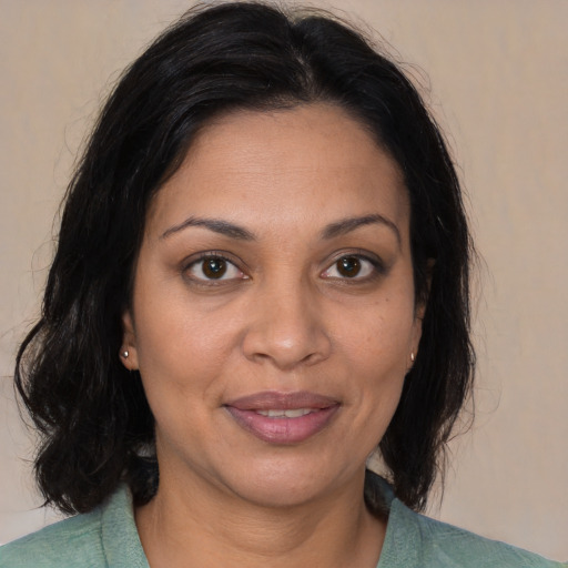 Joyful white adult female with medium  brown hair and brown eyes