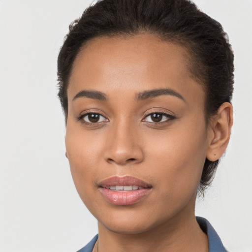 Joyful latino young-adult female with short  brown hair and brown eyes