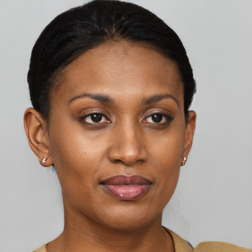 Joyful black young-adult female with short  brown hair and brown eyes