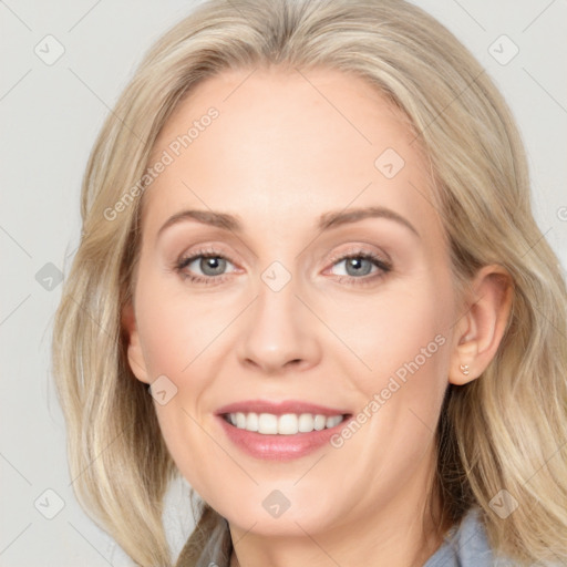 Joyful white adult female with medium  brown hair and blue eyes