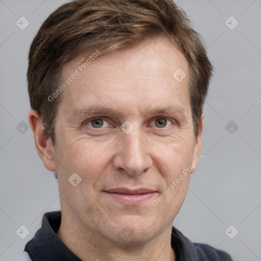 Joyful white adult male with short  brown hair and grey eyes