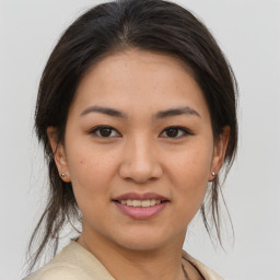 Joyful white young-adult female with medium  brown hair and brown eyes