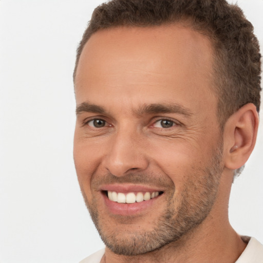 Joyful white adult male with short  brown hair and brown eyes