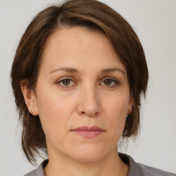 Joyful white adult female with medium  brown hair and grey eyes