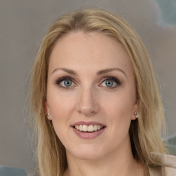 Joyful white young-adult female with long  brown hair and grey eyes