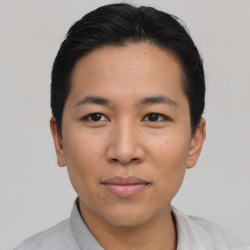 Joyful asian young-adult male with short  black hair and brown eyes