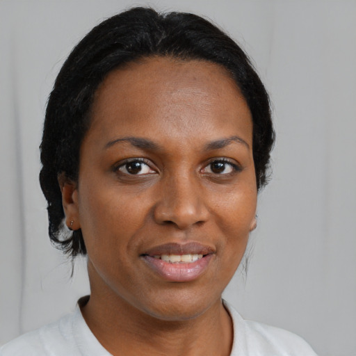 Joyful black adult female with medium  brown hair and brown eyes