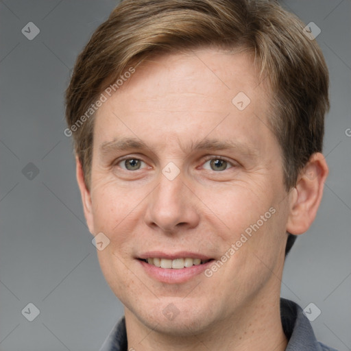 Joyful white adult male with short  brown hair and grey eyes