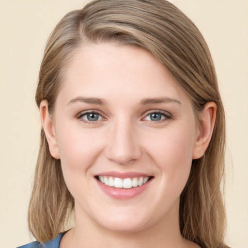 Joyful white young-adult female with long  brown hair and blue eyes