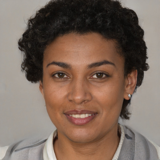 Joyful latino young-adult female with short  brown hair and brown eyes