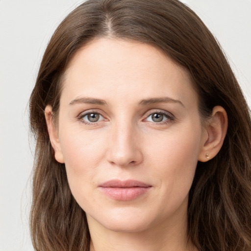 Joyful white young-adult female with long  brown hair and grey eyes