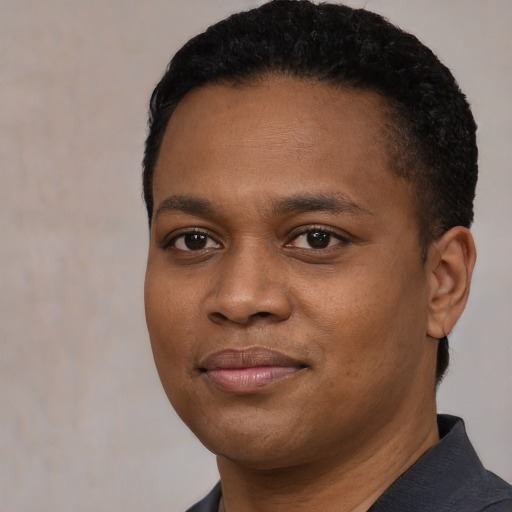 Joyful black young-adult male with short  black hair and brown eyes