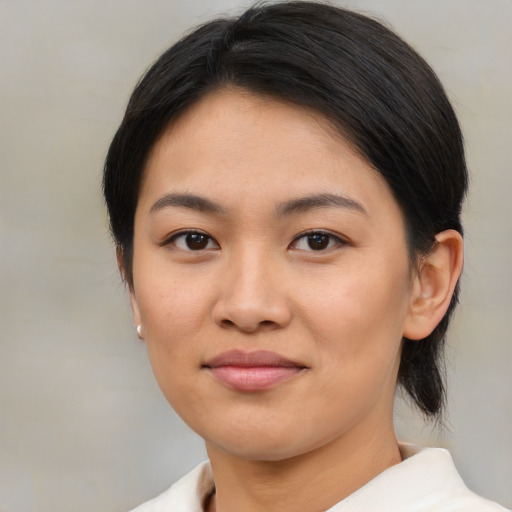 Joyful asian young-adult female with medium  brown hair and brown eyes