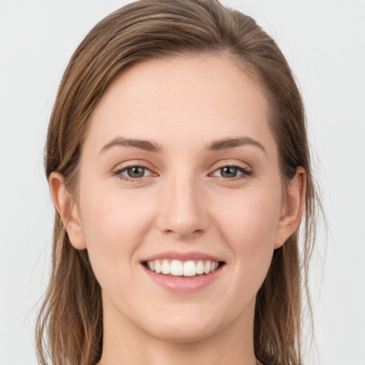 Joyful white young-adult female with long  brown hair and grey eyes