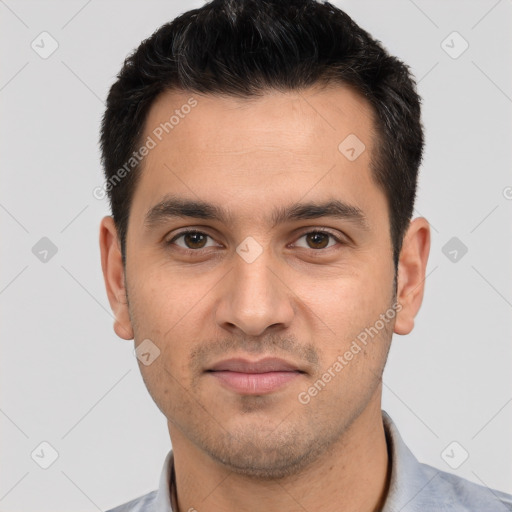 Joyful white young-adult male with short  black hair and brown eyes