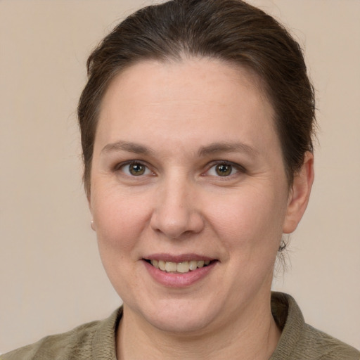 Joyful white adult female with short  brown hair and grey eyes