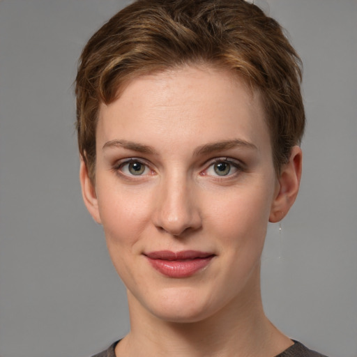 Joyful white young-adult female with short  brown hair and grey eyes