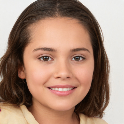 Joyful white child female with medium  brown hair and brown eyes