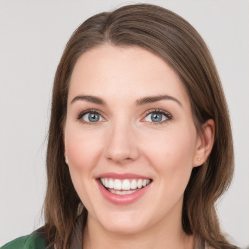 Joyful white young-adult female with long  brown hair and green eyes