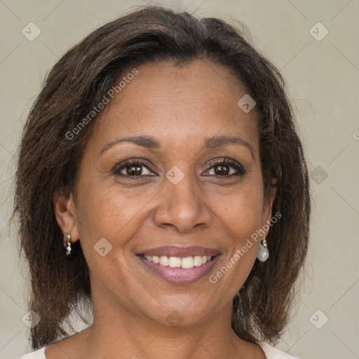 Joyful black adult female with medium  brown hair and brown eyes