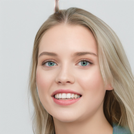 Joyful white young-adult female with long  brown hair and blue eyes