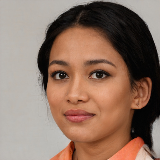 Joyful asian young-adult female with medium  black hair and brown eyes