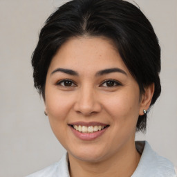 Joyful latino young-adult female with medium  brown hair and brown eyes