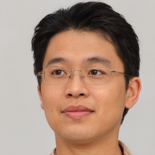 Joyful asian adult male with short  brown hair and brown eyes