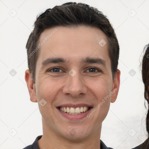 Joyful white young-adult male with short  brown hair and brown eyes