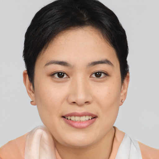 Joyful asian young-adult female with short  brown hair and brown eyes
