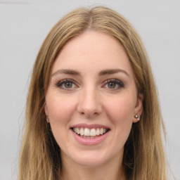 Joyful white young-adult female with long  brown hair and green eyes