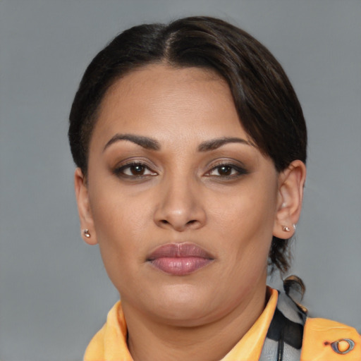 Joyful latino young-adult female with medium  brown hair and brown eyes