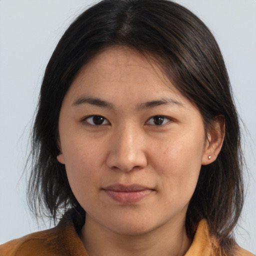 Joyful asian young-adult female with medium  brown hair and brown eyes