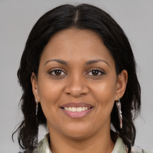 Joyful latino young-adult female with medium  brown hair and brown eyes