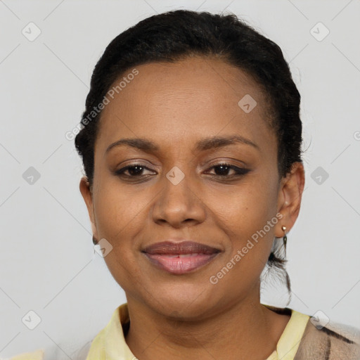 Joyful black young-adult female with short  black hair and brown eyes