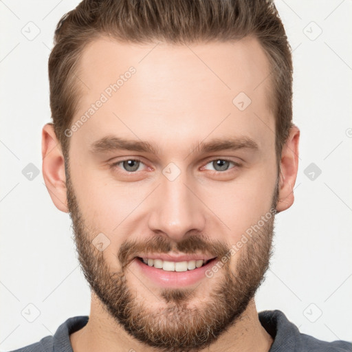 Joyful white young-adult male with short  brown hair and grey eyes