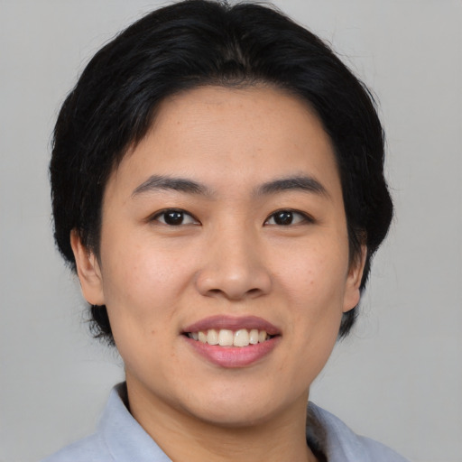 Joyful asian young-adult female with medium  black hair and brown eyes