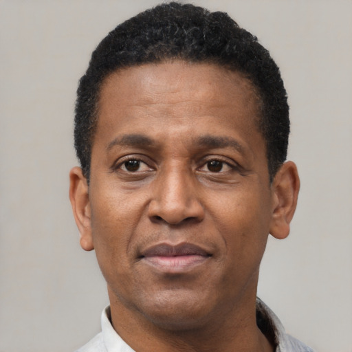 Joyful latino adult male with short  black hair and brown eyes