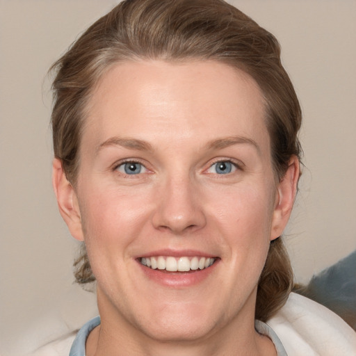 Joyful white adult female with medium  brown hair and grey eyes