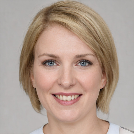 Joyful white young-adult female with medium  brown hair and blue eyes