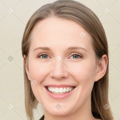 Joyful white young-adult female with medium  brown hair and green eyes