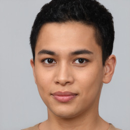 Joyful latino young-adult male with short  brown hair and brown eyes