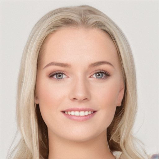 Joyful white young-adult female with long  brown hair and blue eyes