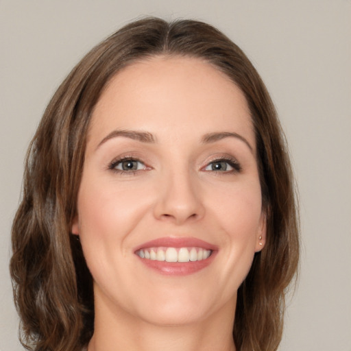 Joyful white young-adult female with medium  brown hair and brown eyes