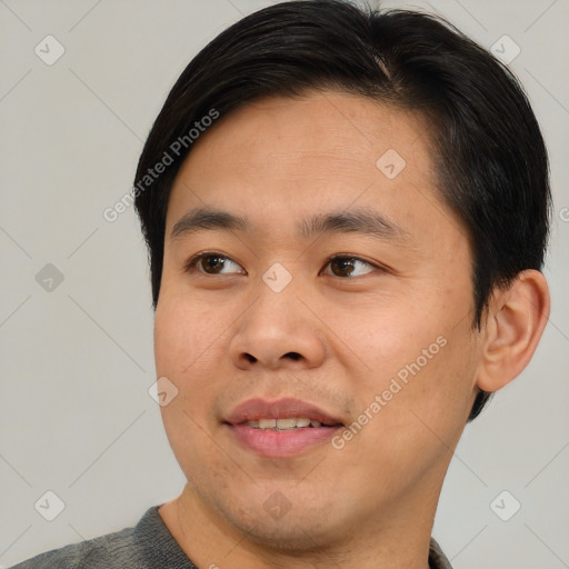 Joyful asian young-adult male with short  brown hair and brown eyes