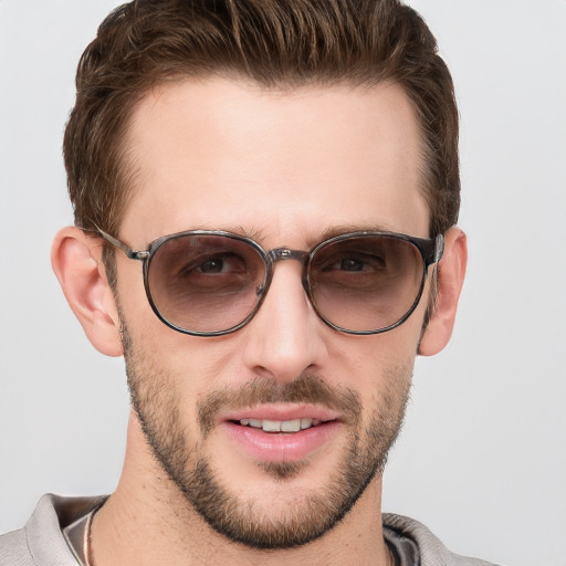 Joyful white young-adult male with short  brown hair and grey eyes