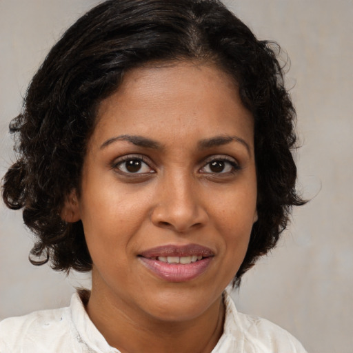 Joyful black young-adult female with medium  brown hair and brown eyes