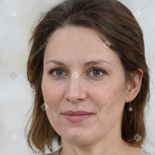 Joyful white adult female with medium  brown hair and grey eyes